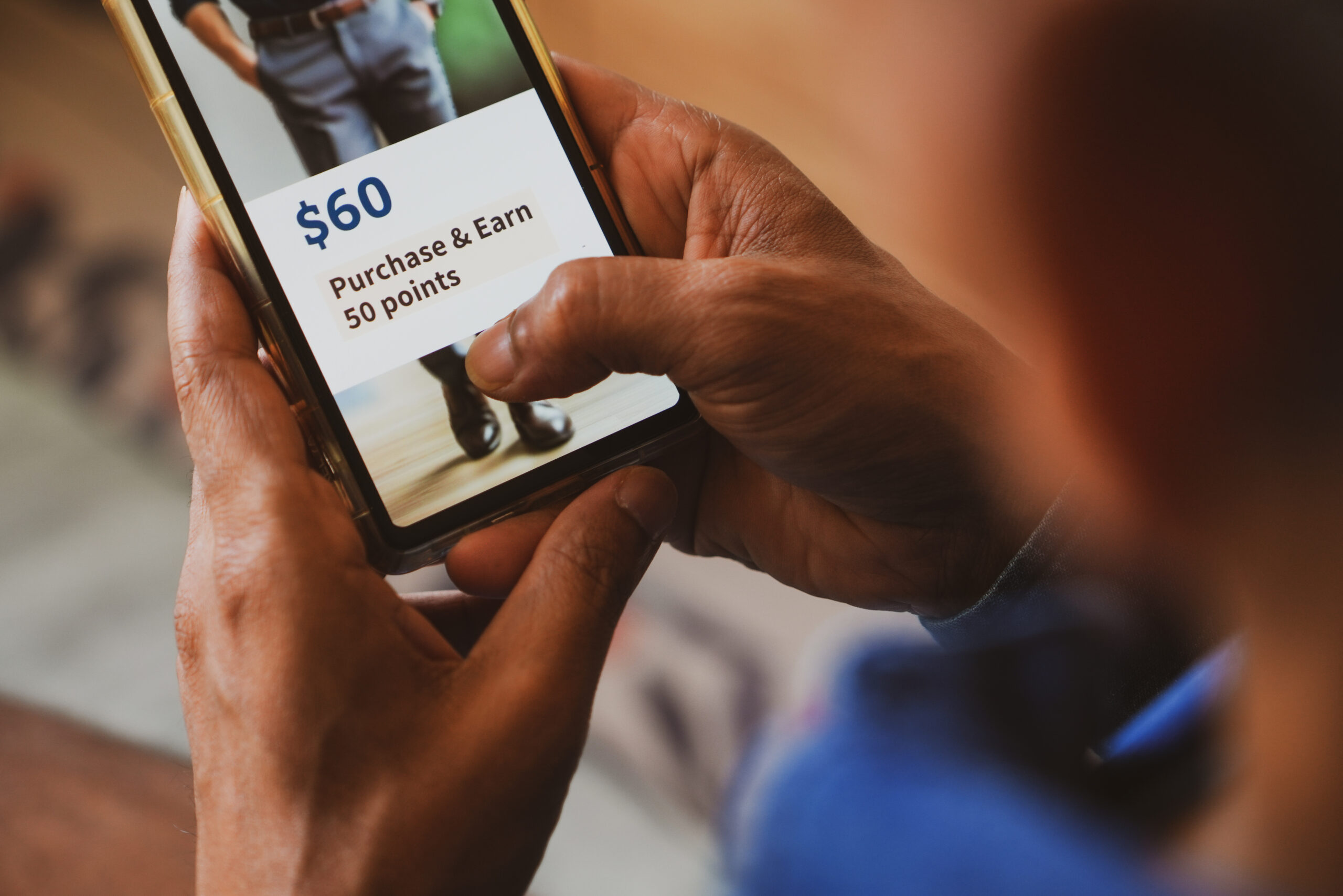 Customer loyalty program concept in e-commerce for customer engagement. Man holding phone displaying earning points after purchasing online.